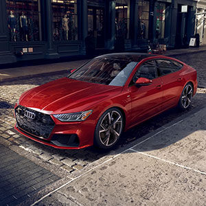 Left side view of an Audi A7 parked at a stoplight.